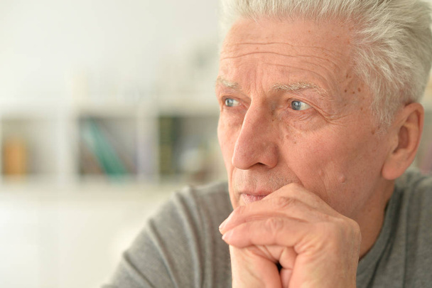 Close up portrait of thoughtful senior man at home - Fotografie, Obrázek