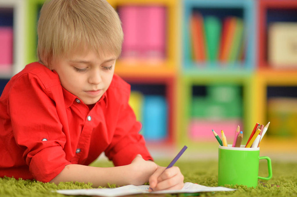 Portrait of cute little boy drawing with pencils - Фото, изображение