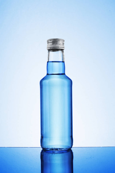 a small bottle of vodka on a white background - Photo, Image