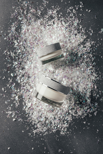 elevated view of beauty cream with decoration shavings on silver - Fotoğraf, Görsel