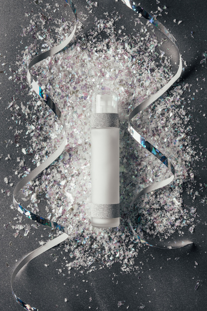 flat lay with festive ribbons and lotion with decorated shavings on silver - Photo, Image