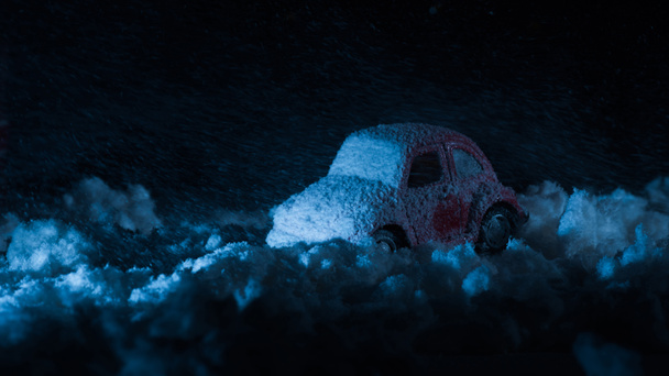 close-up shot of toy car covered with snow in night - Photo, Image
