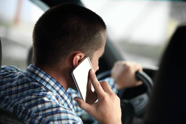 rear view.modern man talking on a smartphone, sitting in the car. - Zdjęcie, obraz