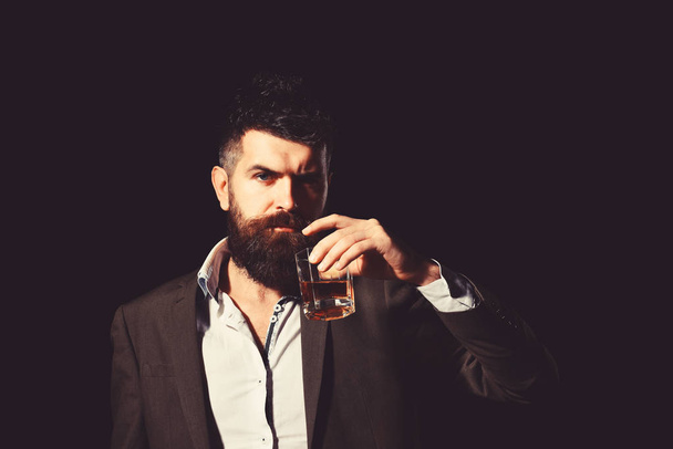 Drinking and alcohol concept. Connoisseur with intelligent look drinks cognac - Fotó, kép