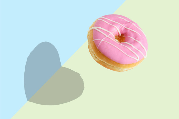 Creative disposition of pink donut on bright background. Minimal food concept. - Fotografie, Obrázek