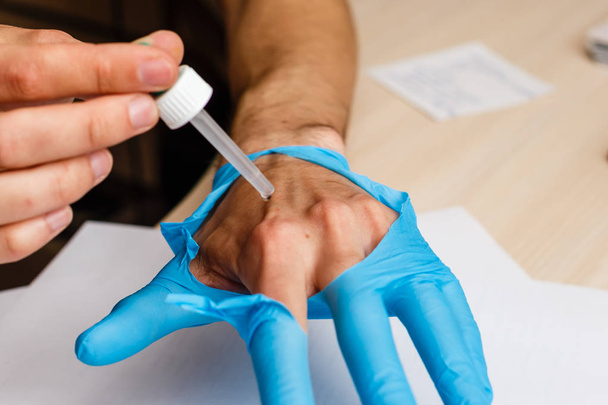 Nahaufnahme von Männerhänden mit Pipette im Labor - Foto, Bild
