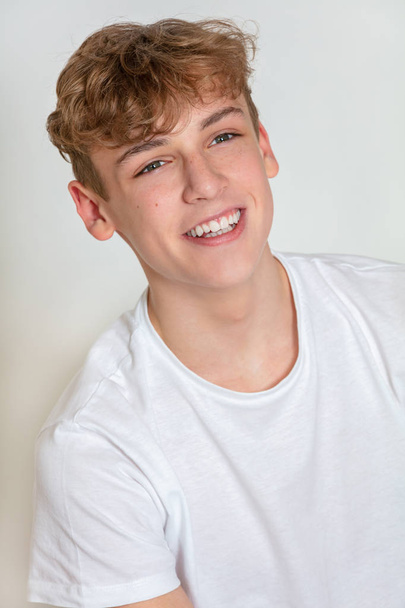 White background studio photograph of young happy boy male teen teenager young adult smiling - Φωτογραφία, εικόνα