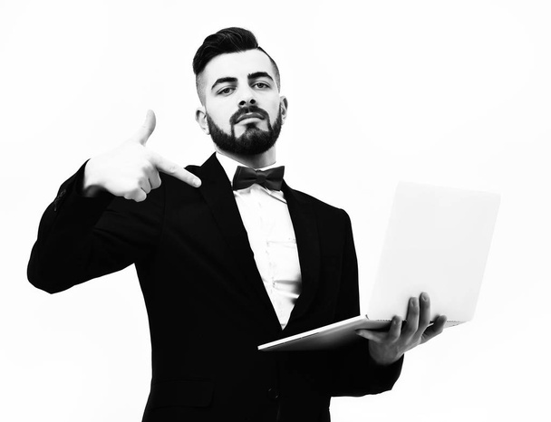 Confident businessman style. Bearded manager with assured face expression holding and pointing at his white notebook, isolated on white background. Concept of successful dea - Zdjęcie, obraz
