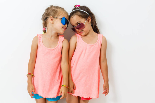 two little girls posing together on white background - Φωτογραφία, εικόνα