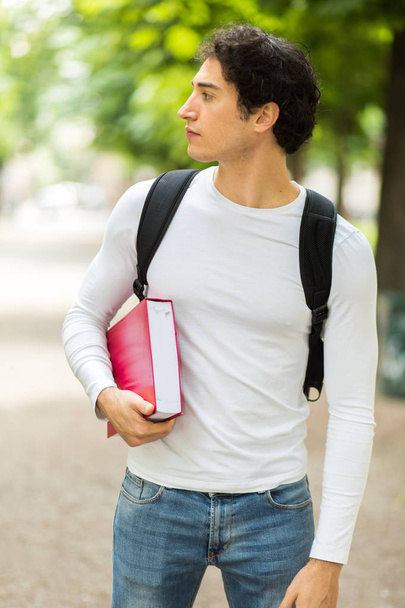 Male student holding book  - Zdjęcie, obraz