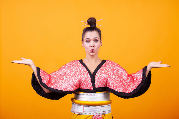 Beautiful young woman wearing japanese costume. Geisha girl - Photo, Image