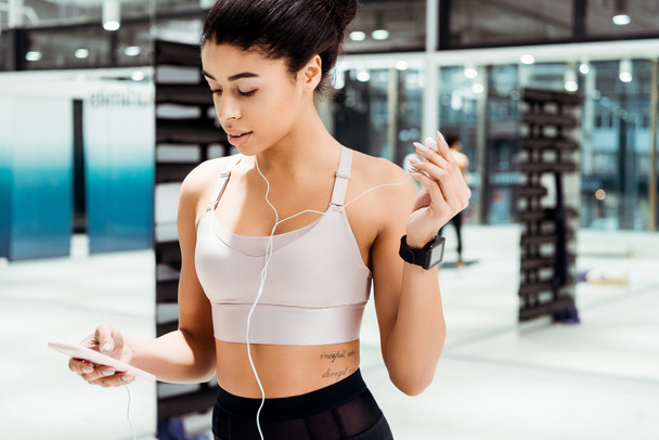 Wonderful sportive girl listening to music  in fitness gym - Photo, Image