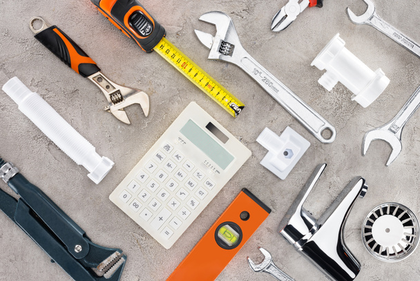 flat lay with various tools and calculator on concrete surface - Photo, Image