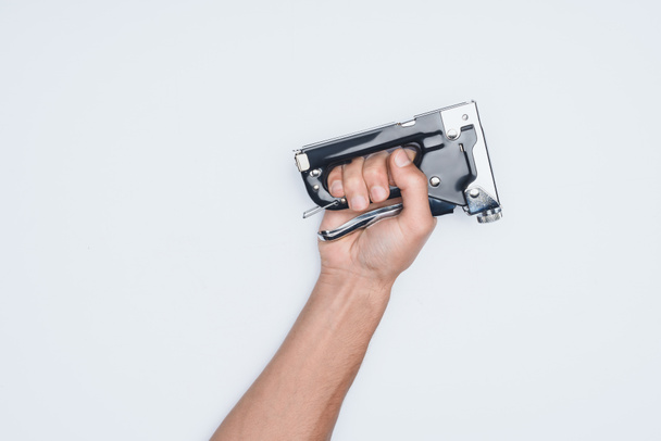 cropped shot of man holding stapler isolated on white - Foto, Imagem