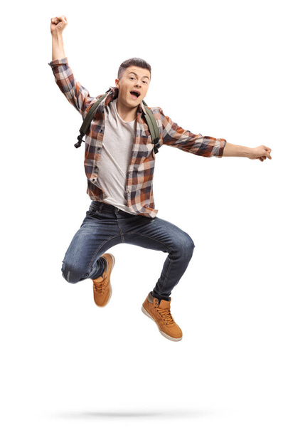 Full length portrait of a joyful teenage student jumping isolated on white background - Valokuva, kuva