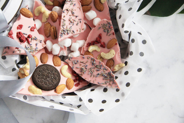 Pieces of chocolate with nuts, berries, lavender, marshmallow, cookies - Foto, afbeelding