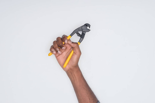 cropped shot of african american man holding cutting pliers isolated on white - Fotoğraf, Görsel