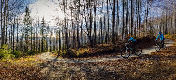 Pyöräily nainen ja mies Beskidy vuorilla metsämaisema. Pari ratsastaa MTB enduro radalla. Ulkoilutoiminta
. - Valokuva, kuva