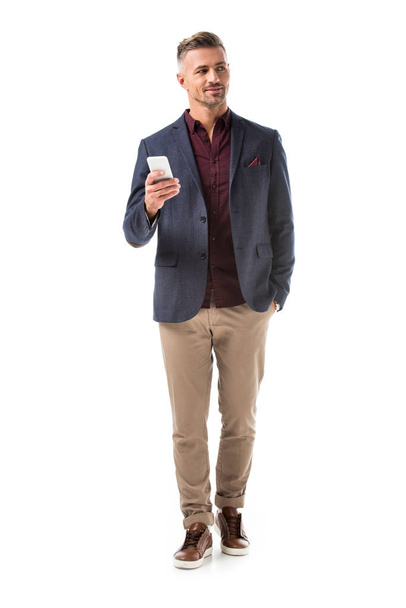 handsome adult stylish man in jacket using smartphone isolated on white - Photo, Image