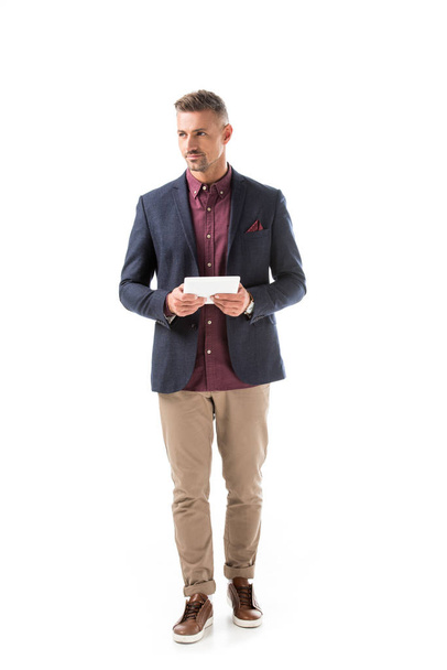 confident stylish man in jacket holding digital tablet isolated on white - Foto, immagini