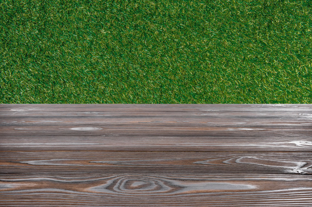 template of brown wooden floor with green grass on background - Fotoğraf, Görsel