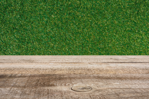 template of brown wooden floor and green grass on background - Foto, afbeelding