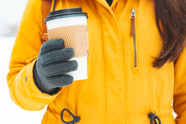 woman holding cup of coffee outside in winter day concept - Photo, Image