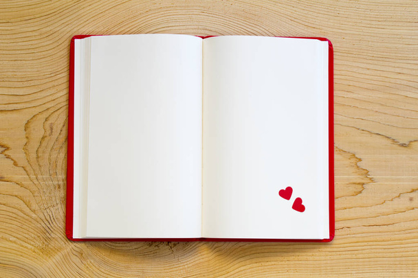 open notebook with red heart on wood background. top view. - Photo, Image