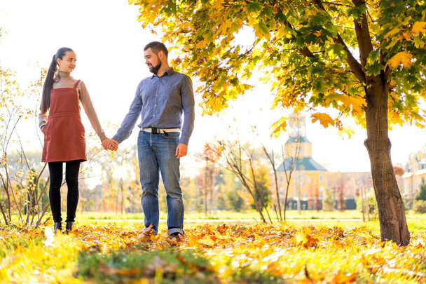 couple in love walking in autumn park - Фото, изображение