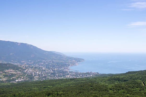 Resort city by the sea. Republic of Crimea, Yalta. 06.13.2018: View of Yalta and the Black Sea from Mount Ai-Petri - Fotografie, Obrázek