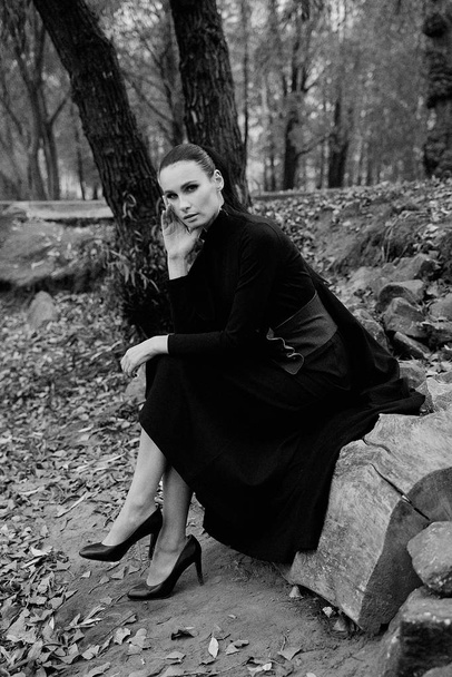 Black and white photo of pretty young fashion model posing outdoors  - Valokuva, kuva