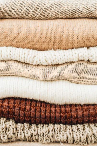Closeup of warm winter sweaters and pullovers. Female minimal fashion clothes pattern. - Photo, Image