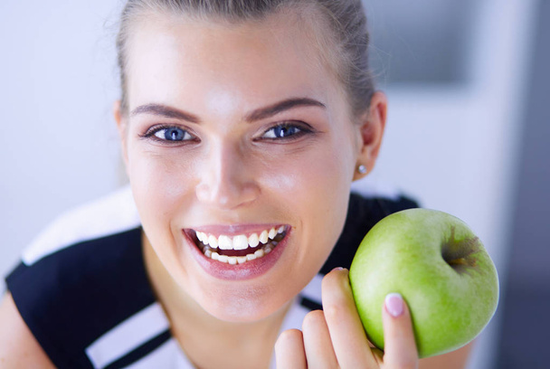 Close up portrait of healthy smiling woman with green apple. - Photo, Image