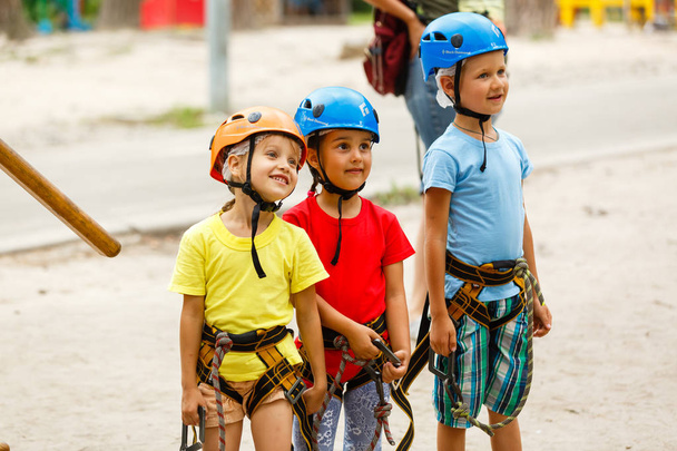 Sonriente niño y niñas en cascos jugando en el parque extremo
 - Foto, imagen