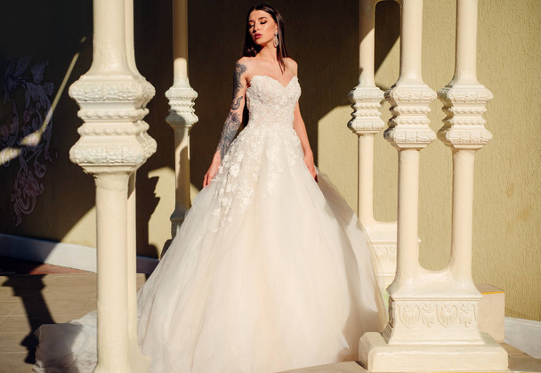 Happy bride before wedding. woman is preparing for wedding. Beautiful wedding dresses in boutique. Elegant wedding salon is waiting for bride. It suits. Wonderful bridal gown. Engagement - Photo, image