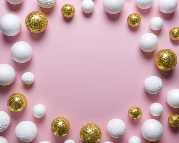 Golden and white glitter ball decoration on pink background with copy space. New Year minimal concept. Flat lay. - Φωτογραφία, εικόνα