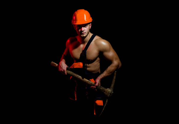 Mining area under construction. Muscular man worker. Hard worker with muscular torso. Construction worker. Man miner with mining equipment. No entry, under construction - Foto, afbeelding