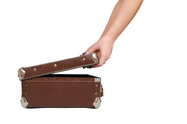 Retro suitcase and female hands isolated on the white background. - 写真・画像