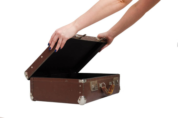 Retro suitcase and female hands isolated on the white background. - Zdjęcie, obraz