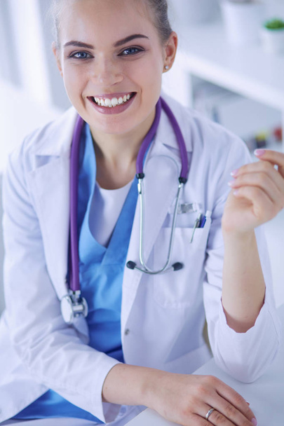 Close up Portrait of friendly female doctor with stethoscope and tablet in hands. - Foto, imagen
