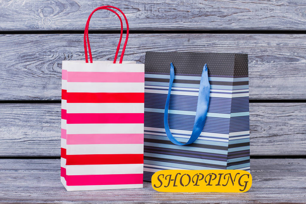 Shopping bags on wooden background. - Фото, зображення