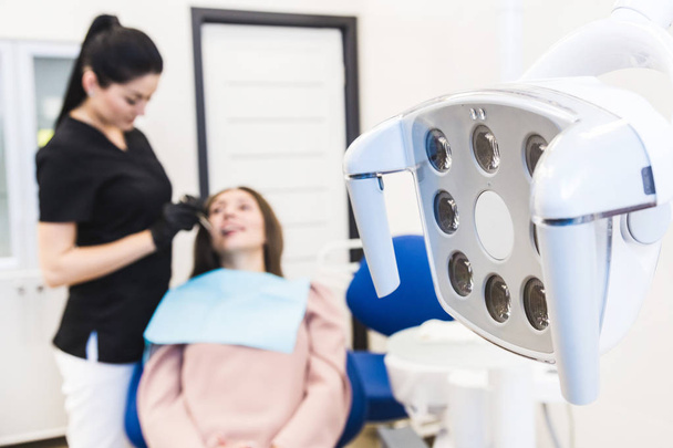 Dental clinic. Reception, examination of the patient. Teeth care. Modern dental equipment. - Fotografie, Obrázek