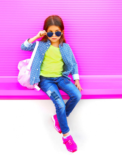 Stylish little girl child on colorful pink wall background - Foto, afbeelding