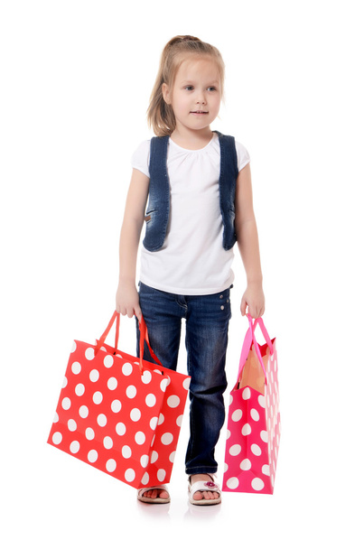 The little girl with two packages isolated - Foto, Imagen