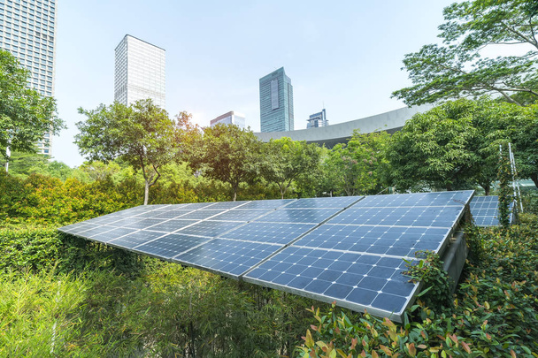 Ecological energy renewable solar panel plant with urban landscape landmarks - Photo, Image