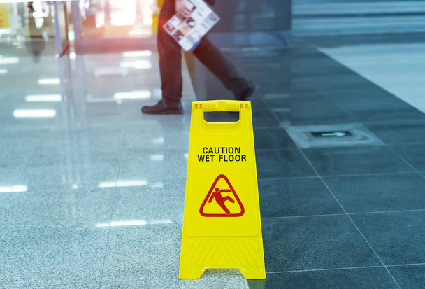 Yellow Caution wet floor sign on wet floor - Photo, Image