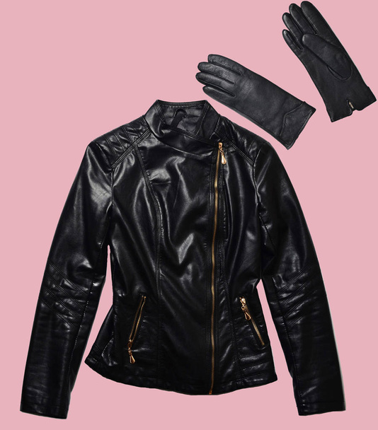 Leather woman's jacket and gloves isolated on pink background. Minimalism, fashionable clothes and accessories - Photo, Image