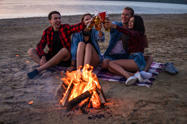 young friends have picnic with bonfire on the beach - Fotoğraf, Görsel