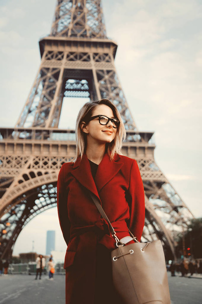 girl in red coat and bag at parisian street - Φωτογραφία, εικόνα
