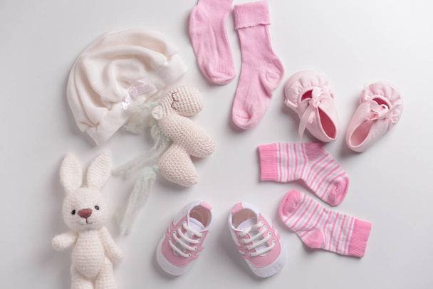 Baby clothes, shoes and toys on white background - Photo, Image